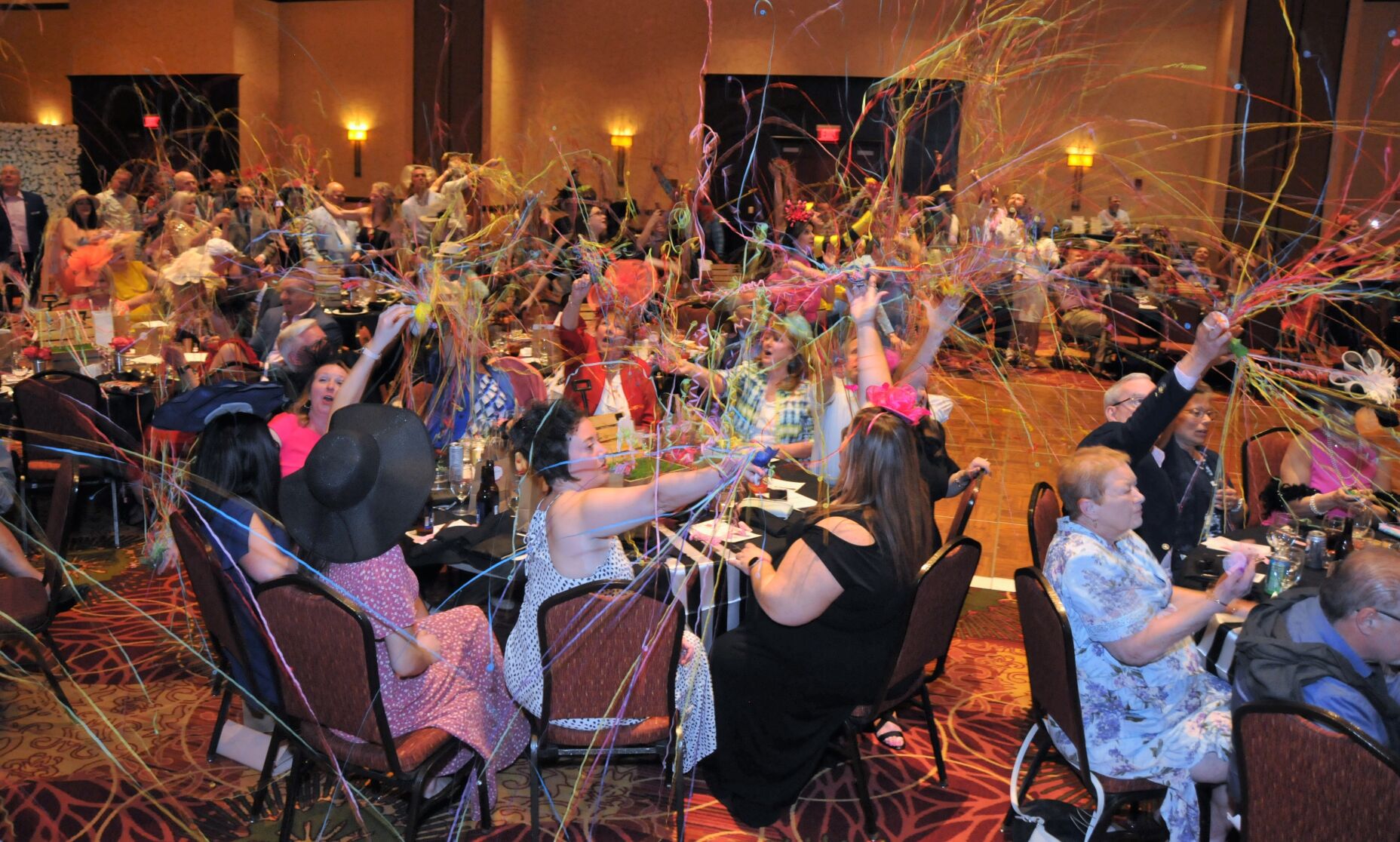 The crowd celebrates with streamers